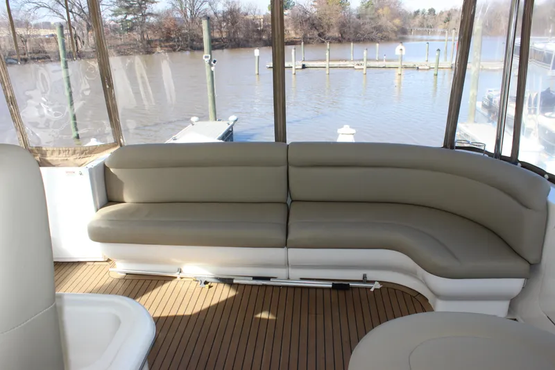 Slide: The Image of 2002 Sea Ray 480 Motor Yacht interior with beige seating and waterfront view. - 17