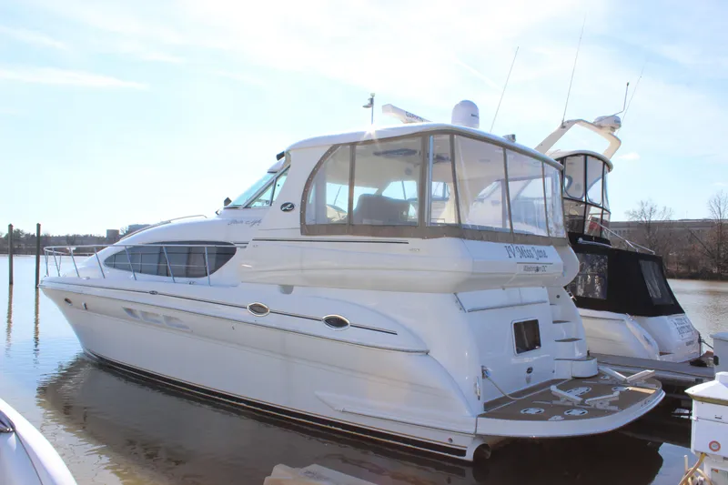 Slide: The Image of 2002 Sea Ray 480 Motor Yacht docked on a sunny day. - 2