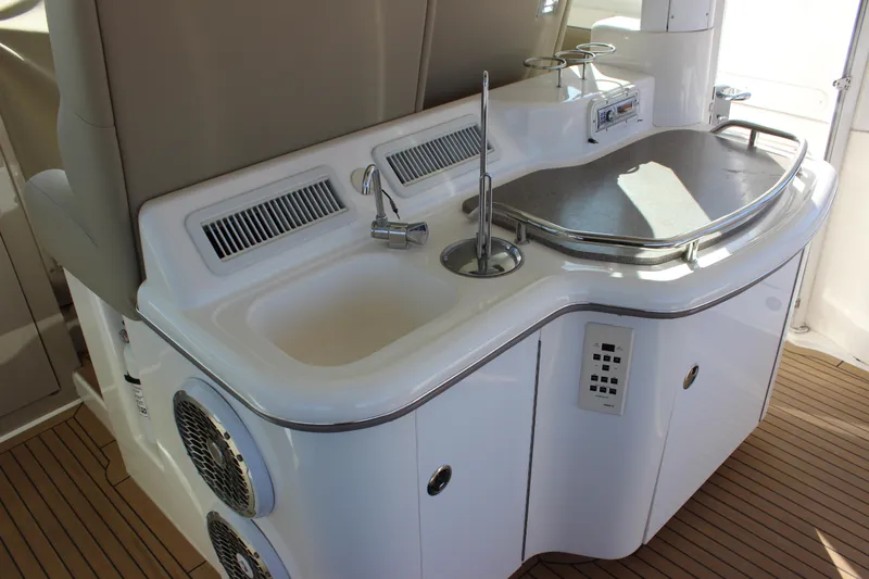 Slide: The Image of 2002 Sea Ray 480 Motor Yacht outdoor kitchen with sink and grill. - 21