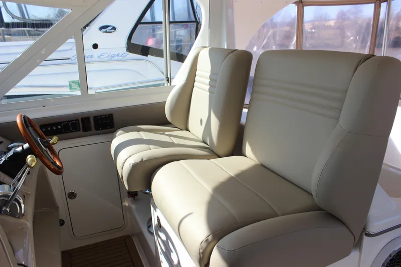 Slide: The Image of 2002 Sea Ray 480 Motor Yacht helm seats and steering wheel. - 23