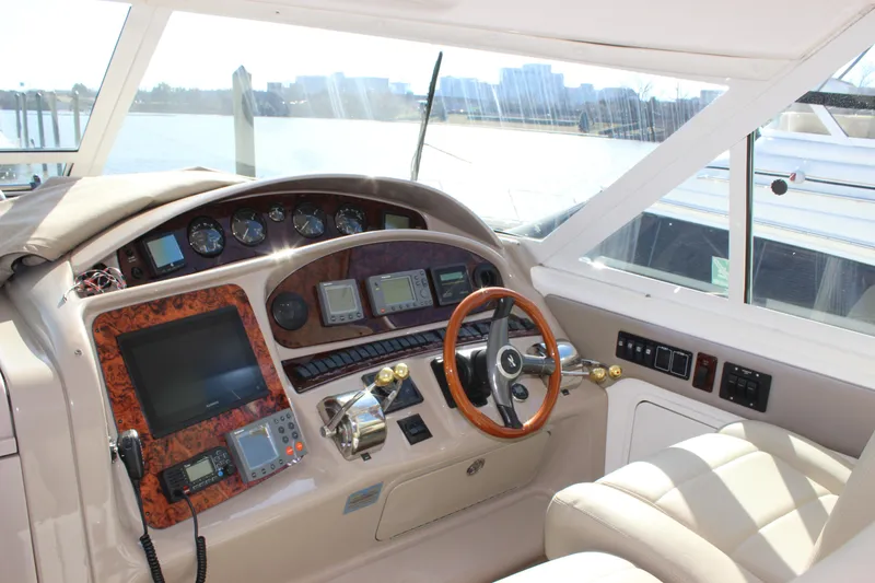 Slide: The Image of 2002 Sea Ray 480 Motor Yacht helm with advanced navigation instruments. - 25
