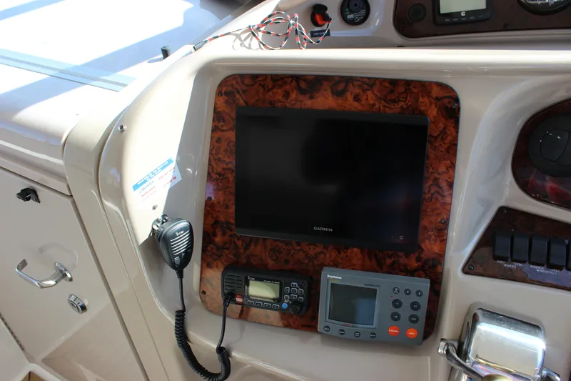 Slide: The Image of Control panel of a 2002 Sea Ray 480 Motor Yacht with navigation and communication equipment. - 27