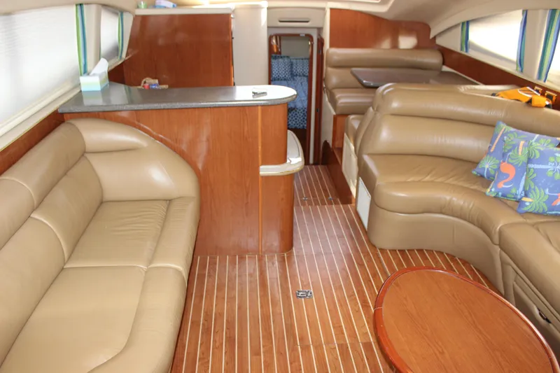Slide: The Image of Interior of 2002 Sea Ray 480 Motor Yacht with leather seating and wooden flooring. - 32