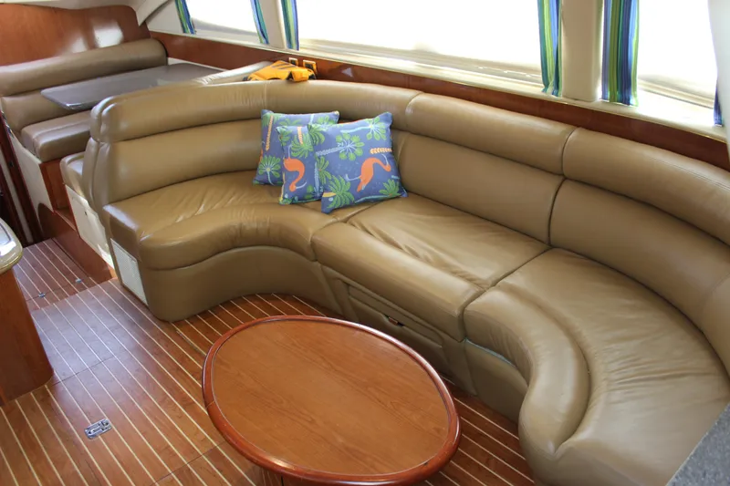 Slide: The Image of Luxurious interior of 2002 Sea Ray 480 Motor Yacht with leather seating and decorative pillows. - 34
