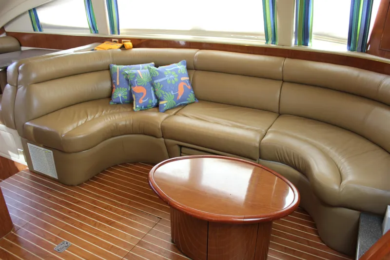 Slide: The Image of Luxurious interior of 2002 Sea Ray 480 Motor Yacht with leather seating and wooden table. - 35