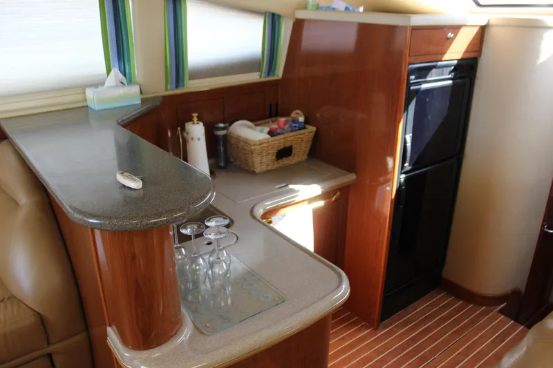 Slide: The Image of 2002 Sea Ray 480 Motor Yacht kitchen with wooden cabinetry and modern appliances. - 36