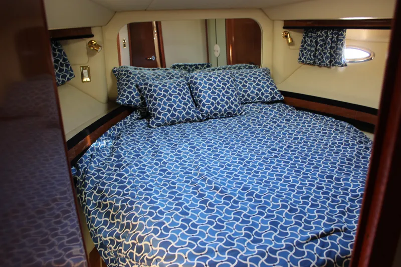 Slide: The Image of Cozy bedroom in 2002 Sea Ray 480 Motor Yacht with blue patterned bedding. - 46