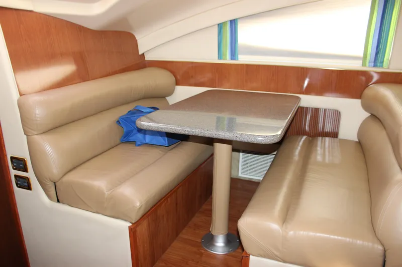 Slide: The Image of 2002 Sea Ray 480 Motor Yacht interior dining area with leather seating and table. - 49
