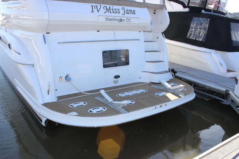 Slide: The Image of 2002 Sea Ray 480 Motor Yacht docked, rear view with IV Miss Jane name and Washington DC registration. - 5