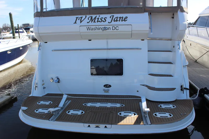 Slide: The Image of 2002 Sea Ray 480 Motor Yacht docked, rear view with IV Miss Jane name and Washington DC registration. - 6