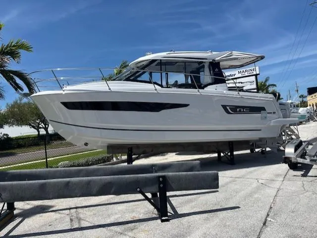 Slide: The Image of 2024 Jeanneau NC Weekender 895 boat on display under clear blue sky. - 0
