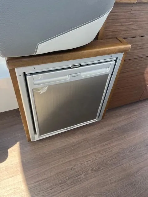 Slide: The Image of Compact refrigerator in 2024 Jeanneau NC Weekender 895 boat interior. - 11