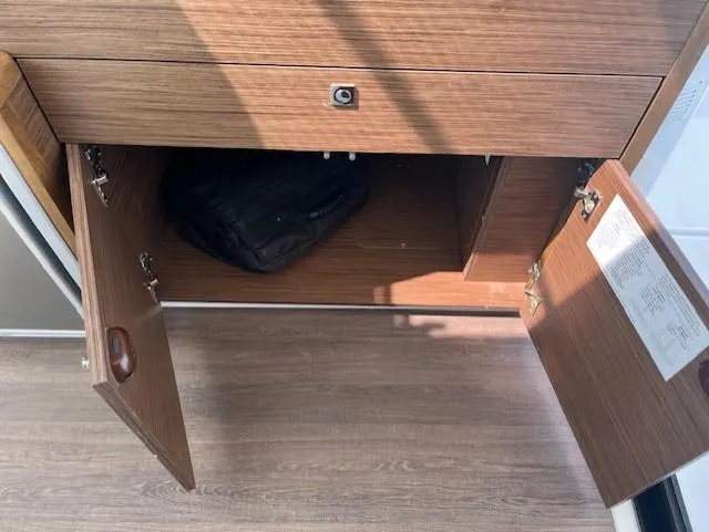 Slide: The Image of Open wooden cabinet on Jeanneau NC Weekender 895 boat, 2024 model. - 13