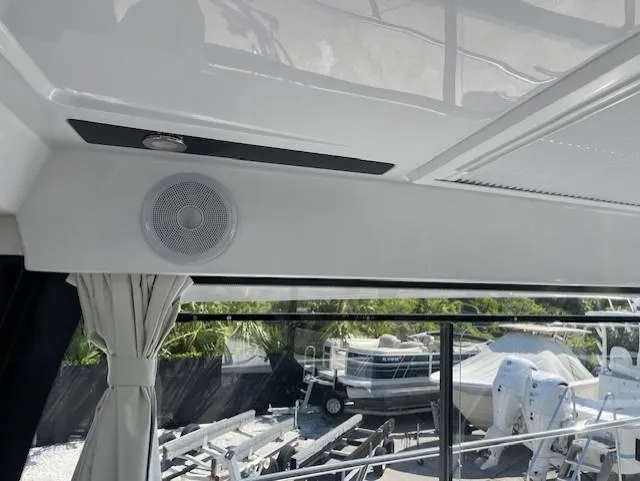 Slide: The Image of Interior view of 2024 Jeanneau NC Weekender 895 with speaker and window curtain. - 14
