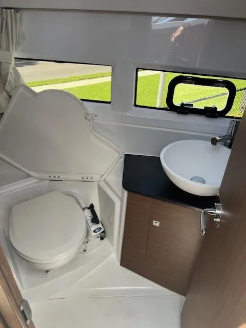 Slide: The Image of 2024 Jeanneau NC Weekender 895 bathroom with toilet and sink. - 15