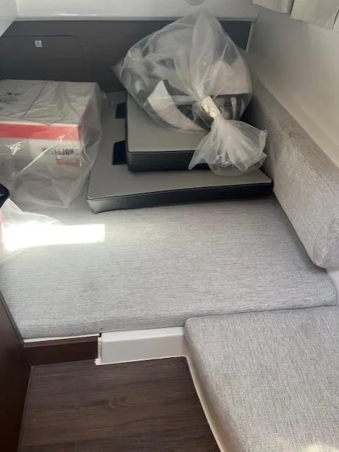 Slide: The Image of 2024 Jeanneau NC Weekender 895 interior cabin with seating and packaged items. - 16