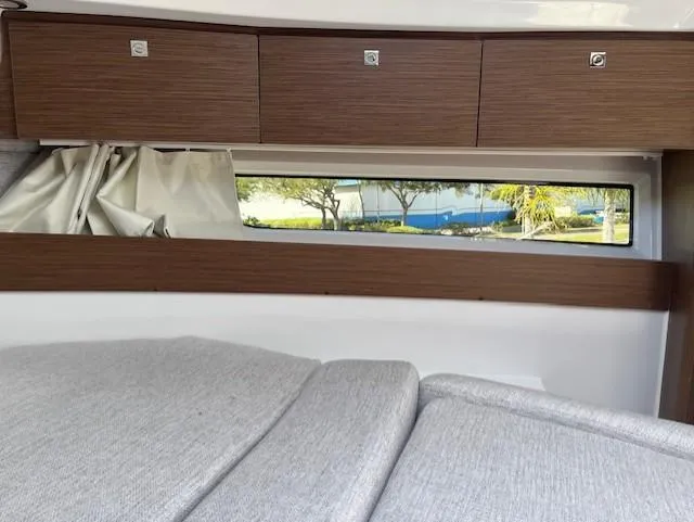 Slide: The Image of Interior cabin of 2024 Jeanneau NC Weekender 895 with wooden cabinets and window. - 18