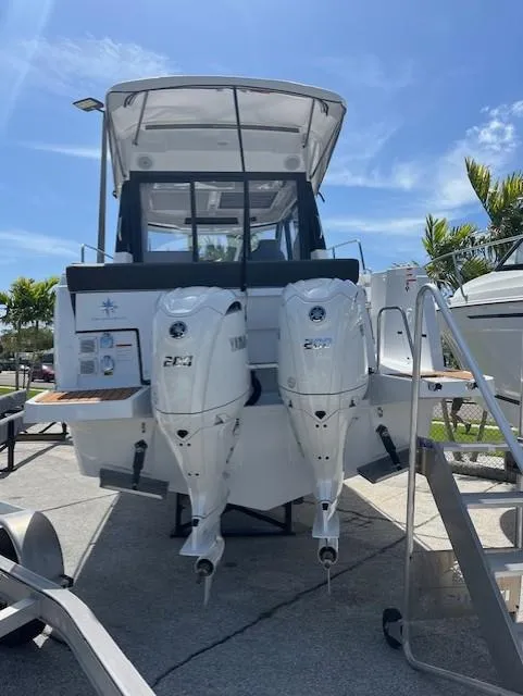 Slide: The Image of 2024 Jeanneau NC Weekender 895 with twin outboard engines. - 2