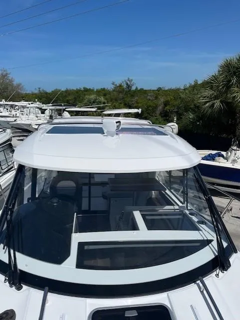 Slide: The Image of 2024 Jeanneau NC Weekender 895 boat with sleek design and panoramic windows. - 4