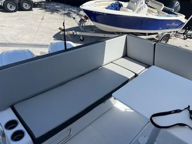 Slide: The Image of 2024 Jeanneau NC Weekender 895 boat interior seating area with table. - 6