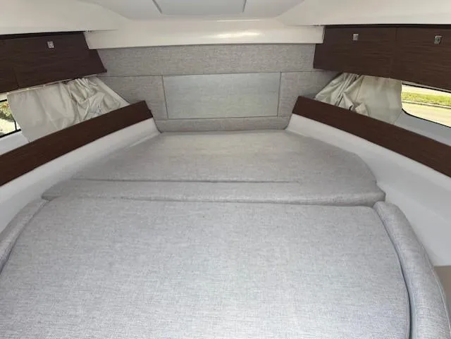 Slide: The Image of 2024 Jeanneau NC Weekender 895 cabin interior with bed and storage compartments. - 9