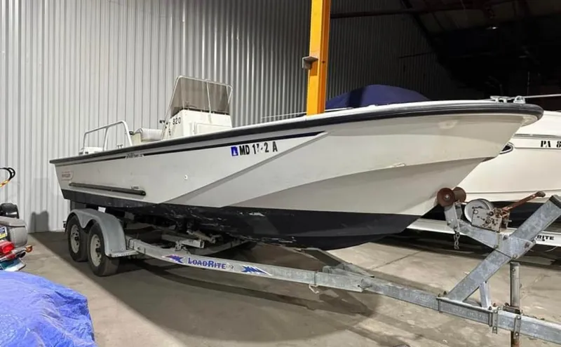 The Image of 1991 Boston Whaler Outrage Cuddy 22 on trailer in storage facility. - 1