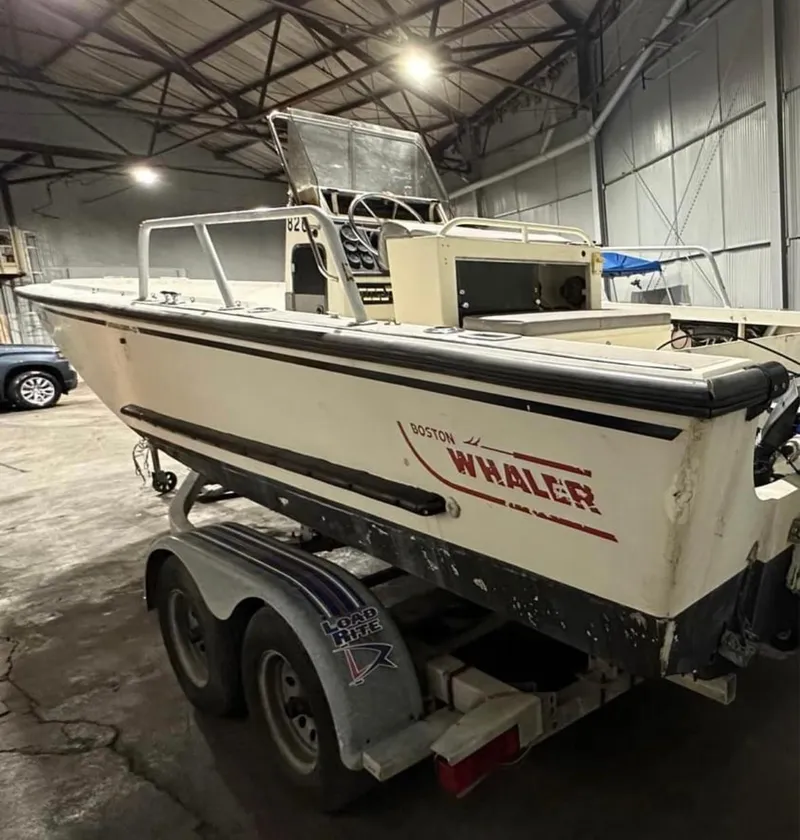 Slide: The Image of 1991 Boston Whaler Outrage Cuddy 22 on trailer in warehouse setting. - 4