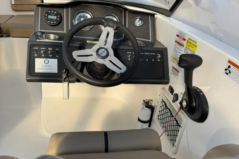 Slide: The Image of 2022 Bayliner VR 6 boat dashboard with steering wheel and control panel. - 6