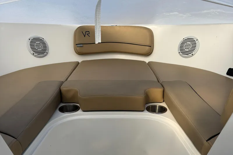 Slide: The Image of 2022 Bayliner VR 6 boat interior with cushioned seating and cup holders. - 7