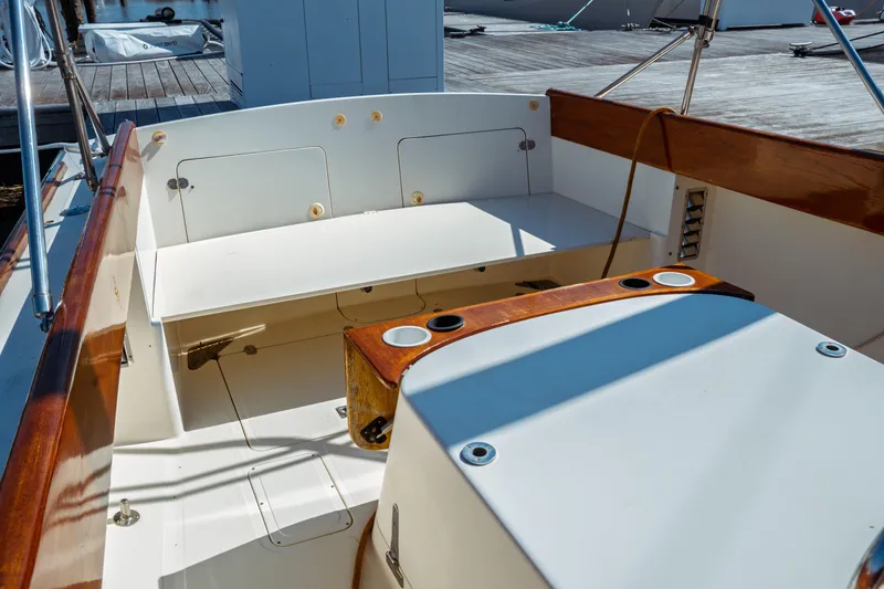 Slide: The Image of 2000 Hinckley Picnic Boat Classic interior with wooden accents and seating area. - 20