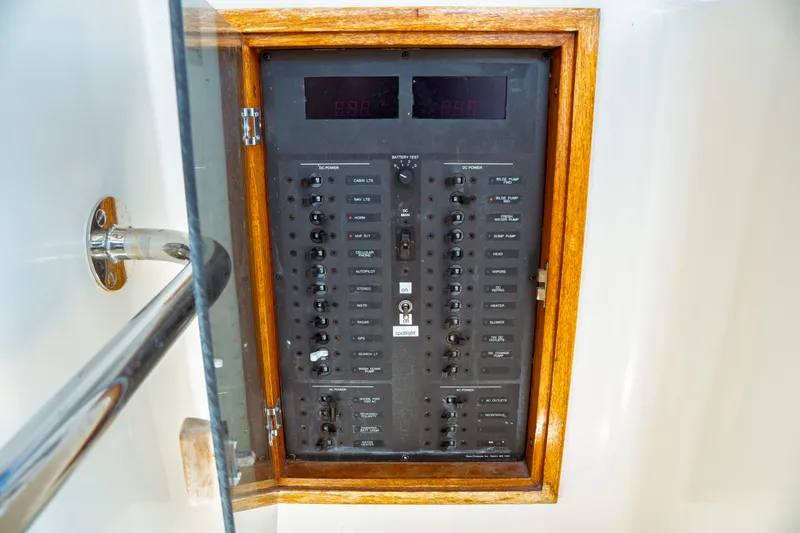Slide: The Image of Electrical panel on a 2000 Hinckley Picnic Boat Classic, featuring switches and controls. - 40