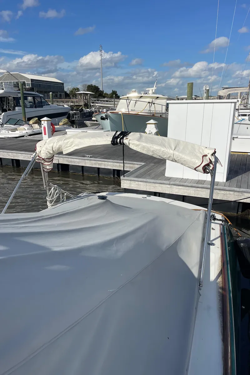 Slide: The Image of Hinckley Picnic Boat Classic 2000 docked at marina with cover on. - 14
