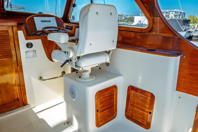Slide: The Image of Interior of 2000 Hinckley Picnic Boat Classic with wooden accents and captain's chair. - 24