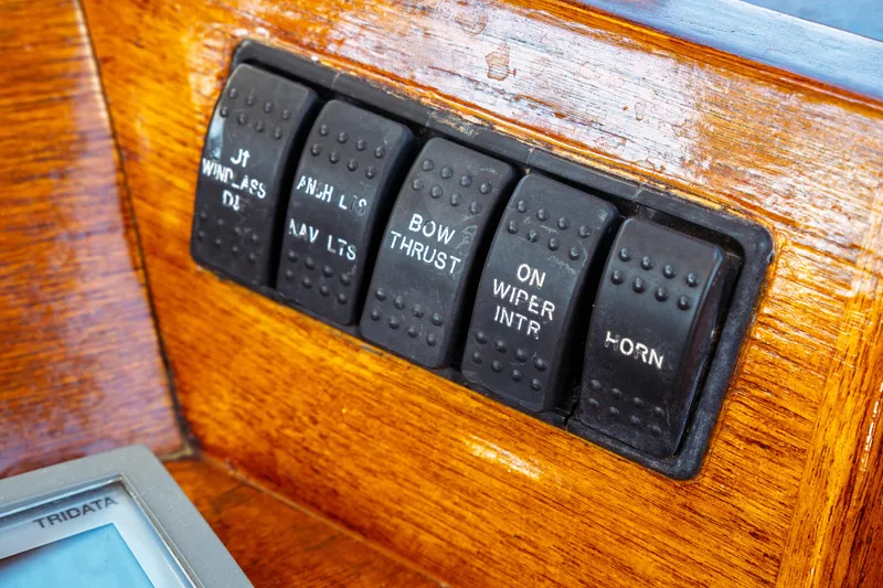 Slide: The Image of Control panel of a 2000 Hinckley Picnic Boat Classic with labeled switches. - 34