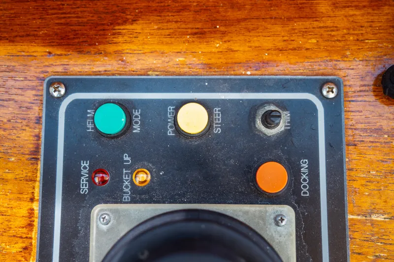 Slide: The Image of Control panel of a 2000 Hinckley Picnic Boat Classic with various buttons and switches. - 37