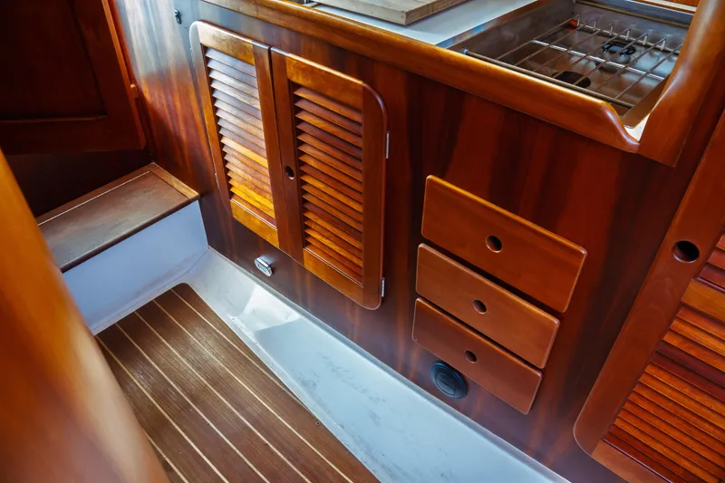 Slide: The Image of Interior of 2000 Hinckley Picnic Boat Classic with wooden cabinetry and flooring. - 44