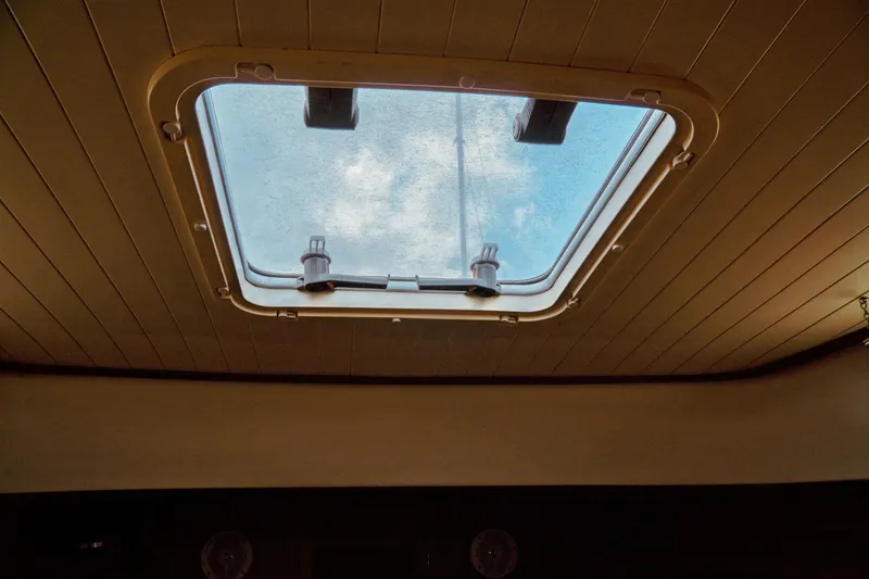 Slide: The Image of Skylight view from 2000 Hinckley Picnic Boat Classic, showcasing blue sky and clouds. - 61