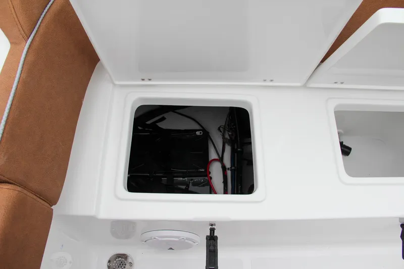 Slide: The Image of Open storage compartments on a 2024 Sea Hunt Ultra 234 boat. - 12