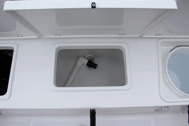 Slide: The Image of Open storage compartment on a 2024 Sea Hunt Ultra 234 boat. - 13