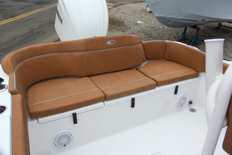 Slide: The Image of 2024 Sea Hunt Ultra 234 boat with brown cushioned seating. - 16