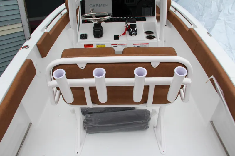 Slide: The Image of 2024 Sea Hunt Ultra 234 boat interior with rod holders and Garmin navigation system. - 17