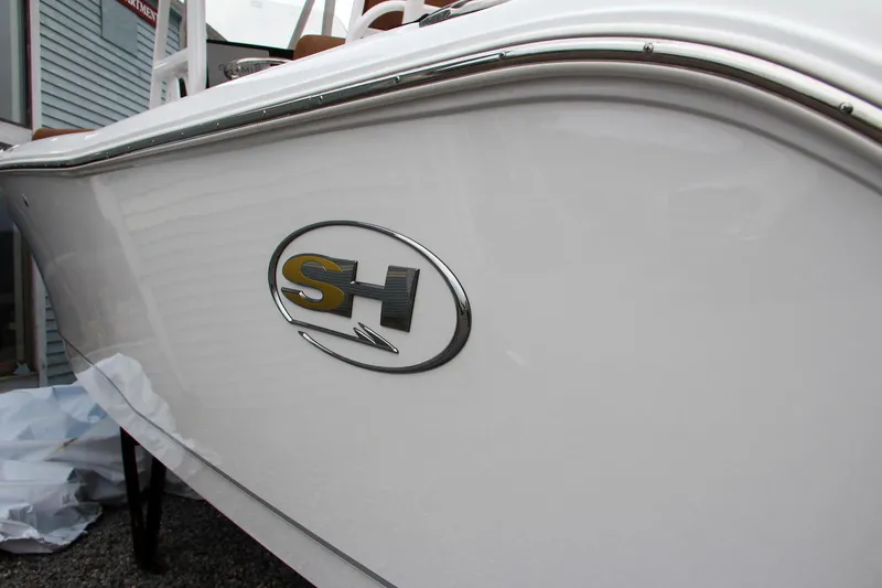 Slide: The Image of 2024 Sea Hunt Ultra 234 boat side view with SH logo. - 2