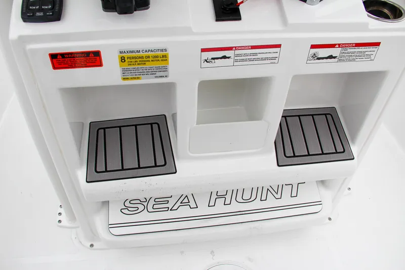 Slide: The Image of 2024 Sea Hunt Ultra 234 boat console with storage compartments and Sea Hunt branding. - 26