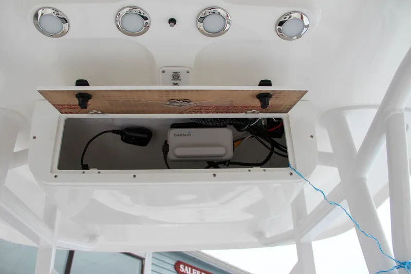 Slide: The Image of 2024 Sea Hunt Ultra 234 electronics compartment with wiring and equipment. - 29