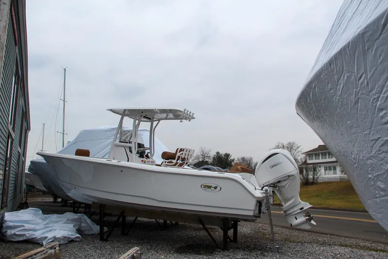 Slide: The Image of 2024 Sea Hunt Ultra 234 boat on a trailer, covered for storage. - 3