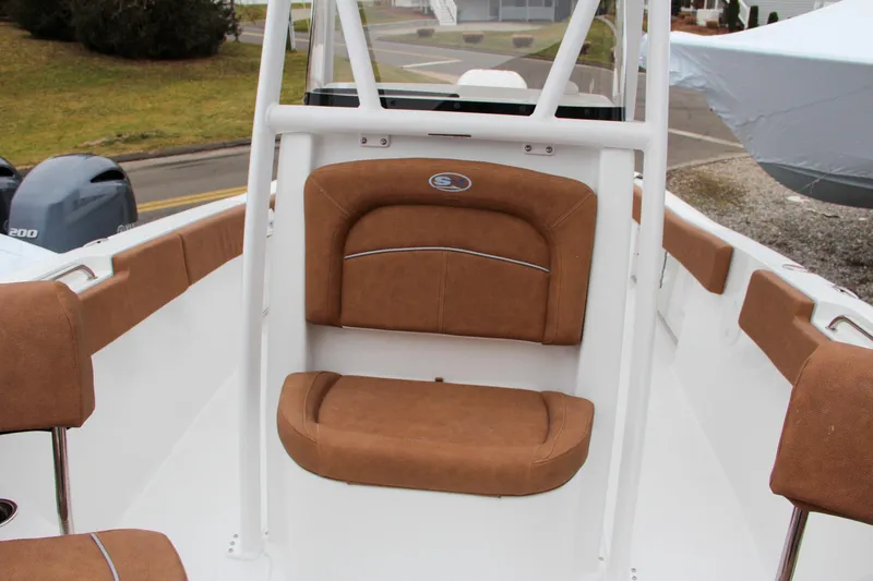 Slide: The Image of 2024 Sea Hunt Ultra 234 boat interior with tan cushioned seating. - 32