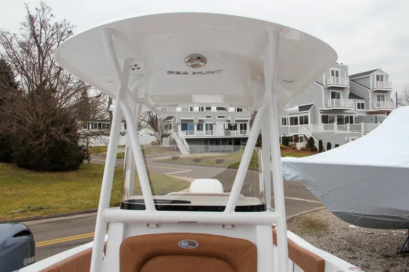 Slide: The Image of 2024 Sea Hunt Ultra 234 boat with T-top and brown seating. - 33