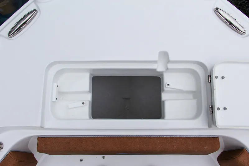 Slide: The Image of 2024 Sea Hunt Ultra 234 boat storage compartment with cushioned seating. - 37