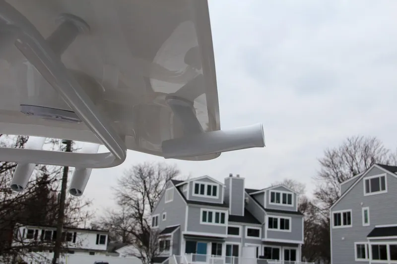 Slide: The Image of Close-up of 2024 Sea Hunt Ultra 234 boat with houses in the background. - 38