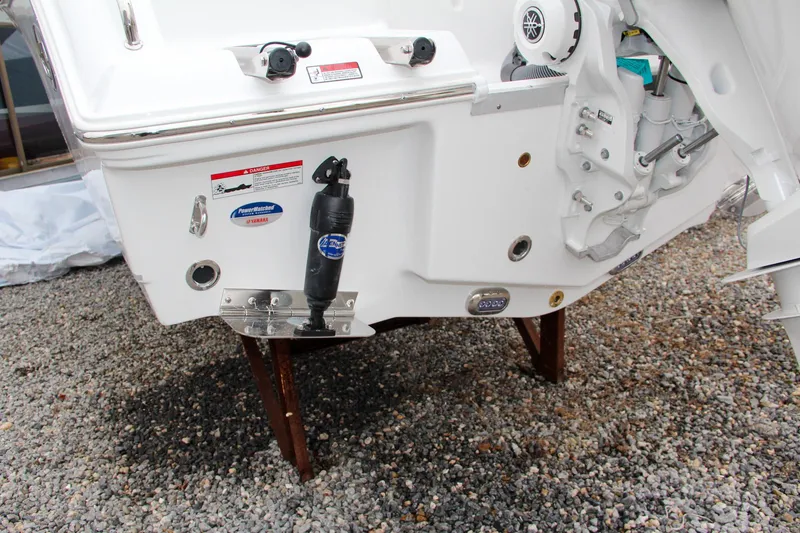 Slide: The Image of 2024 Sea Hunt Ultra 234 boat stern on gravel. - 6
